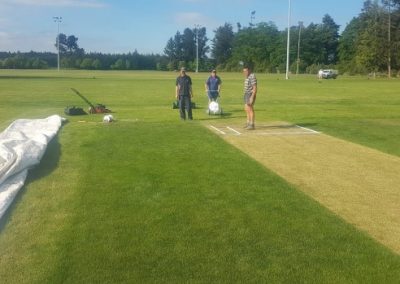 Pleasant Point Cricket Club members work on the grass wicket ahead of their first game on the ground on Saturday.